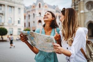 Patient smiling with their clear aligners traveling with friend