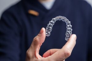 person holding clear aligner